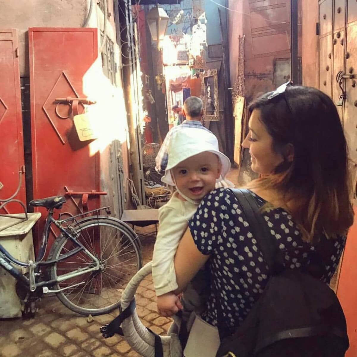 Yasmin holding her son, in a souk in Morocco.