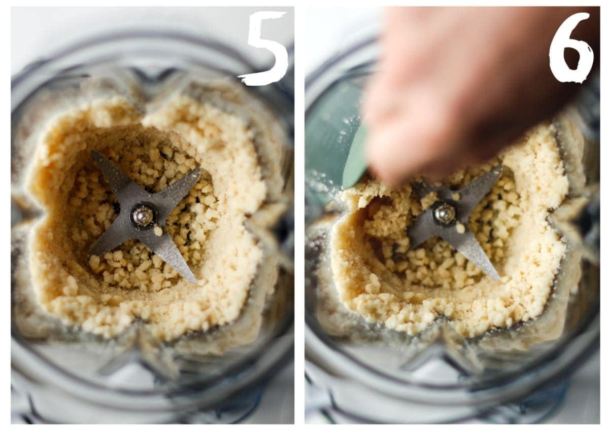 Macadamia nuts in the blender jug being scraped down towards the blades with a spatula.