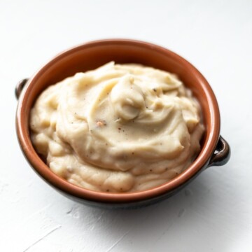 A bowl of the creamed celeriac with roasted celeriac pieces.