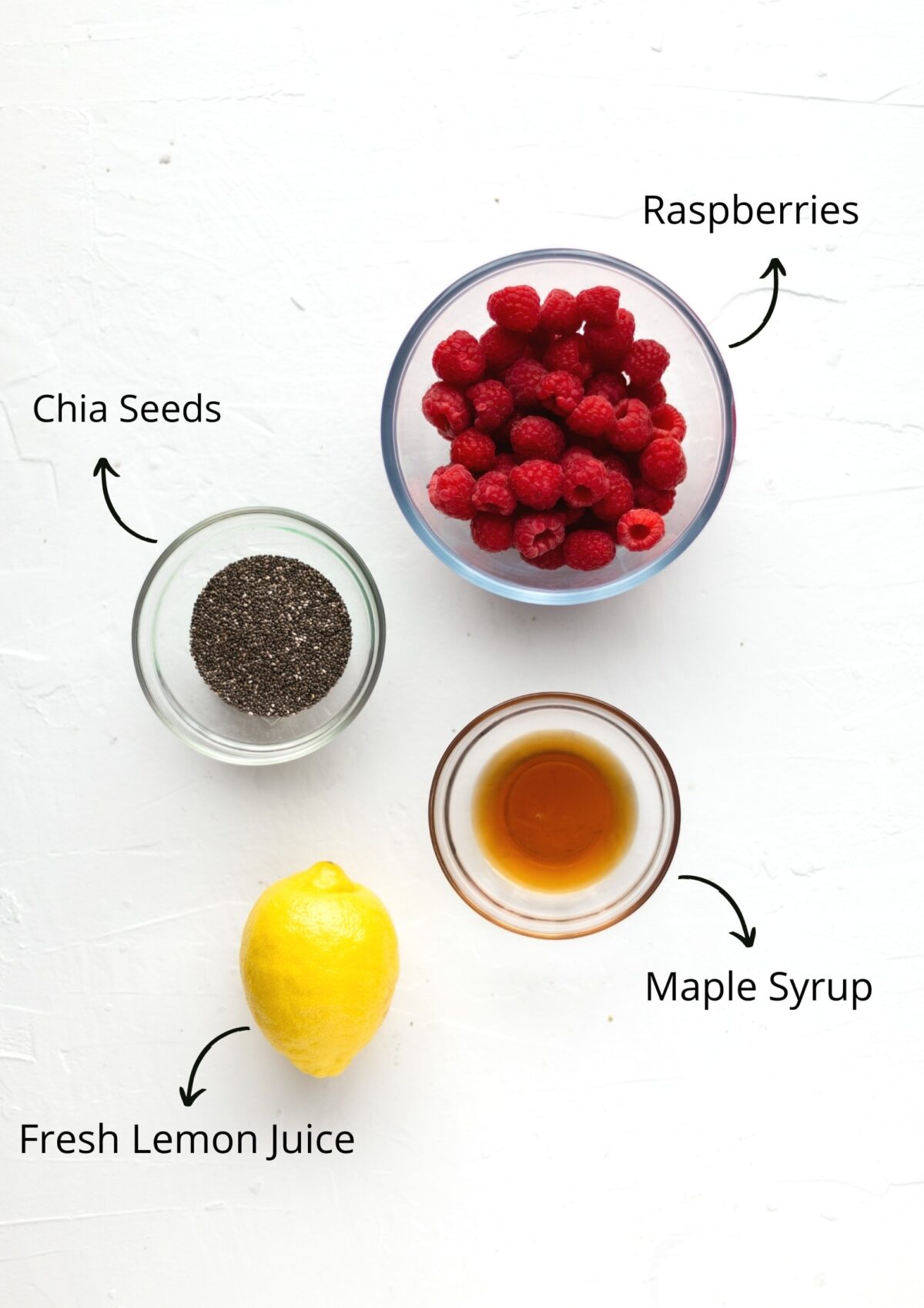 Over head shot of the vegan chia jam ingredients on a white background.