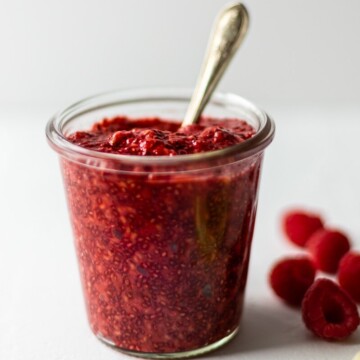 Jar of chia jam with a spoon in.