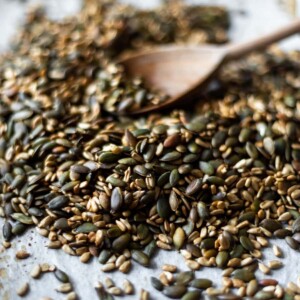 Side shot of the roasted tamari seeds on the baking tray after roasting.