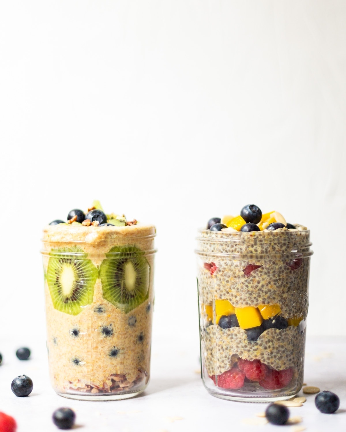 A photo with two mason jars, one filled with flaxseed pudding and fresh fruit, the other filled with chia and flaxseed pudding, with more fresh fruit.