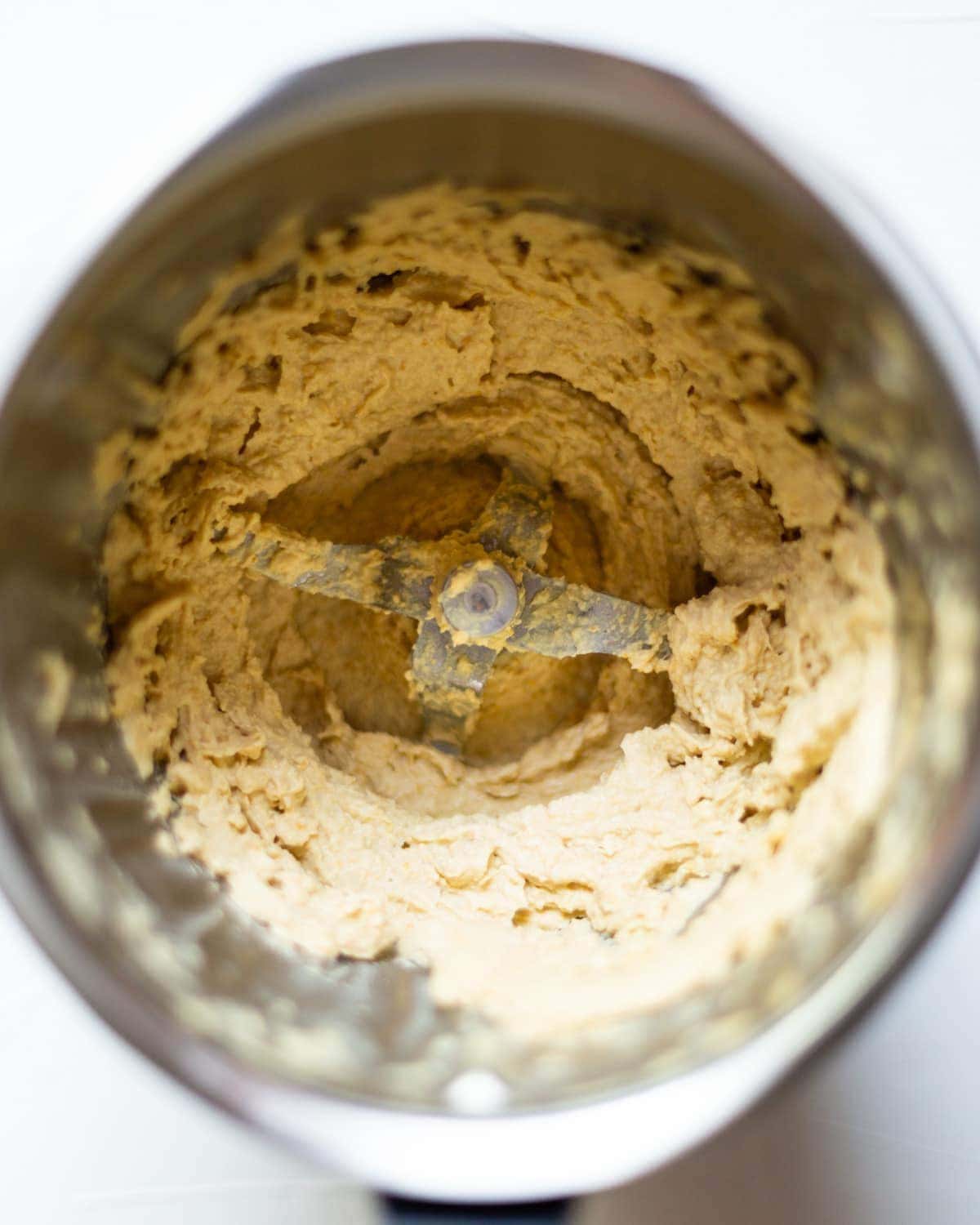The Thermomix filled with freshly blended classic hummus.