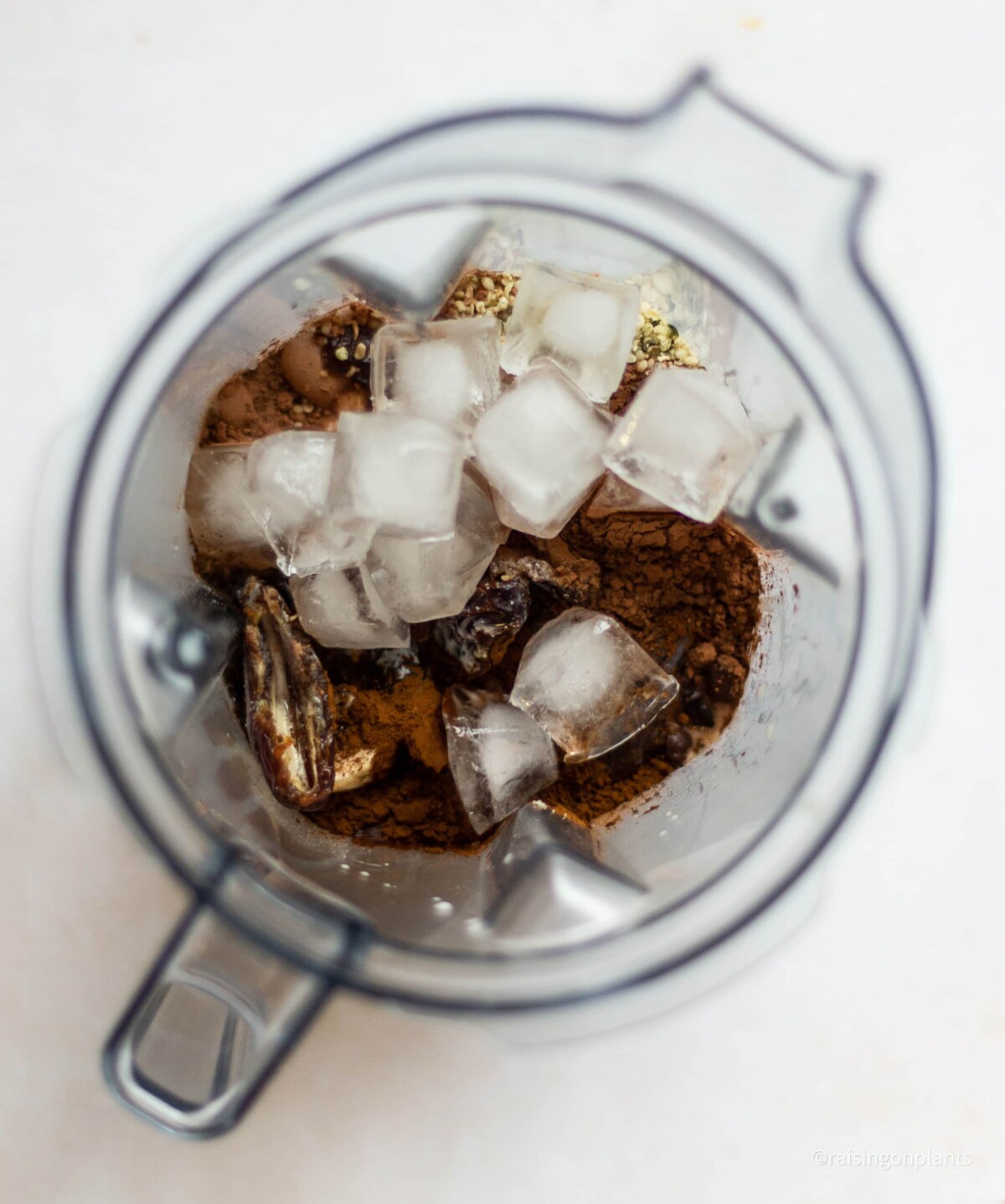 The blender jug filled with both wet and dry ingredients.