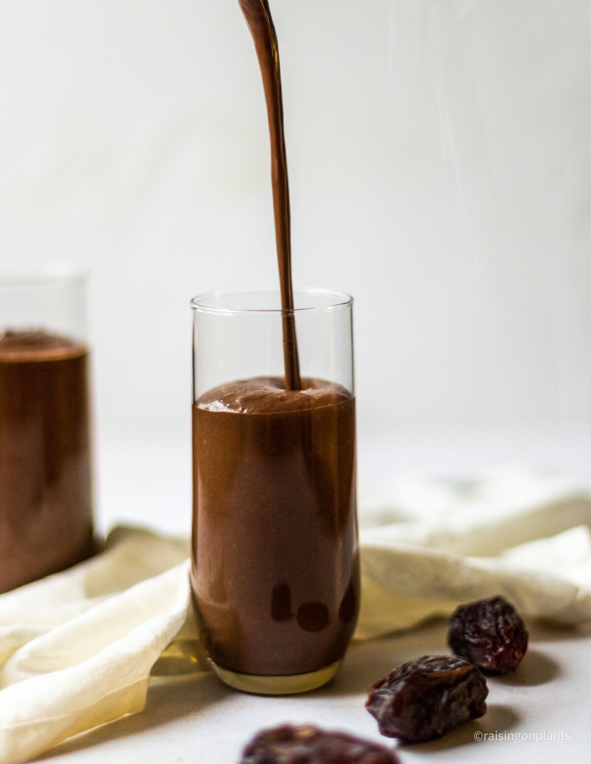 Pouring the smoothie in to a glass.